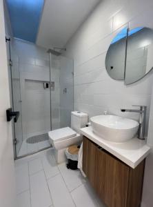 a bathroom with a sink and a toilet and a shower at Cuenca Hotel Apartment in Cuenca +12 photos
