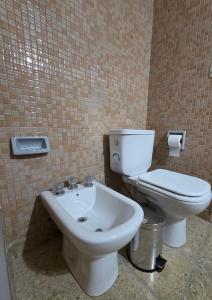 a bathroom with a toilet and a sink at Casa LIDIA Hostel in Comodoro Rivadavia +33 photos
