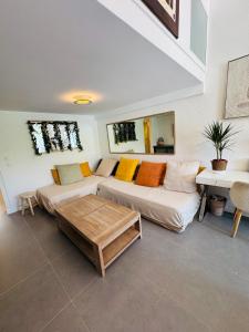 a living room with a couch and a table at Coeur Créole in Saint Barthelemy +29 photos