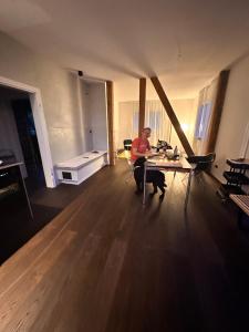 a man sitting at a table in a living room at HAUS AM SEE - Natur Pur in Friedenweiler +84 photos