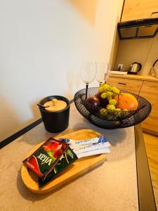 a counter with a plate of food and a bowl of fruit at Apartament PLAY in Pietrzykowice