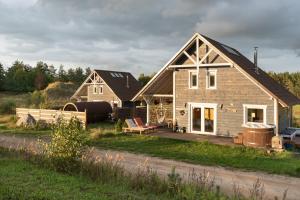 a home with a wooden deck and a house at Czaplowisko - skandynawskie domy na Kaszubach in Stare Czaple