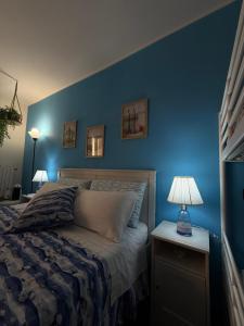 a bedroom with blue walls and a bed with a lamp at Al Bastione B&B in Barletta