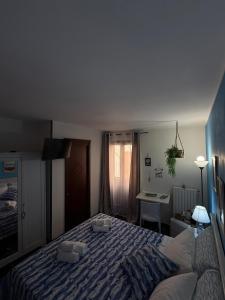 a bedroom with a large bed and a desk at Al Bastione B&B in Barletta