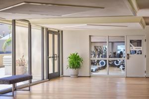 an empty room with a chair and glass doors at DoubleTree by Hilton San Jose in San Jose