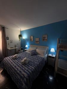 a blue bedroom with a bed with two towels on it at Al Bastione B&B in Barletta +56 photos