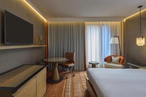 a hotel room with a bed and a table and chair at Hilton London Tower Bridge in London +98 photos