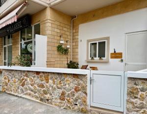 a restaurant with a stone counter in front of a building at Irene’s house in Koskinou
