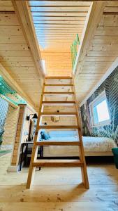 a loft bed in a tiny house at Czaplowisko - skandynawskie domy na Kaszubach in Stare Czaple +66 photos