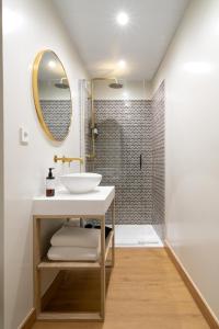 a bathroom with a sink and a shower at Casa Carver 1927 by Hommyhome in Seville
