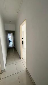 a hallway with a white wall and an open door at CasaLisa beach House in Langstrand