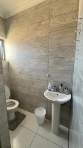 a bathroom with a sink and a toilet at CasaLisa beach House in Langstrand