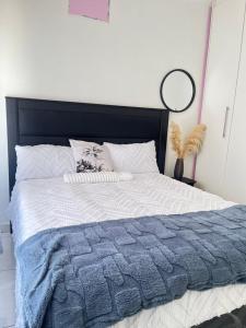 a bedroom with a large bed with a blue and white comforter at CasaLisa beach House in Langstrand