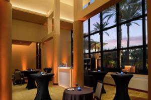 a restaurant with tables and chairs and large windows at DoubleTree Suites by Hilton Phoenix in Phoenix