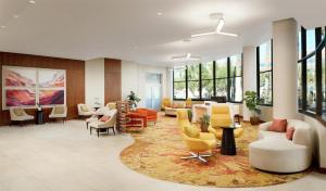 a lobby with a waiting area with chairs and tables at DoubleTree Suites by Hilton Phoenix in Phoenix