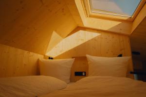 two beds in a room with a window at cabinski Montafon in Sankt Gallenkirch