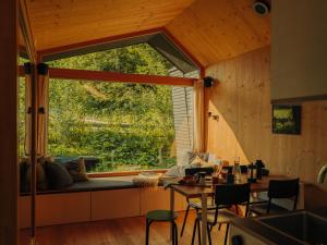 a living room with a large window in a house at cabinski Montafon in Sankt Gallenkirch
