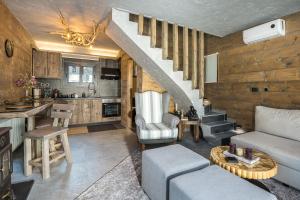 a living room with a staircase and a kitchen at LF Parnassos Chalet in Eptalofos