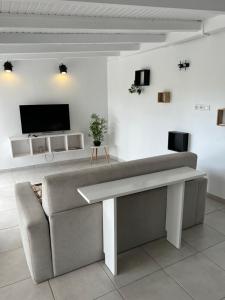 a living room with a couch and a flat screen tv at Le Loft in Pointe-à-Pitre