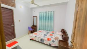 a bedroom with a bed and a mirror and a window at Hotel Grand Nuria in Habiganj