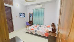 a small bedroom with a bed and a window at Hotel Grand Nuria in Habiganj