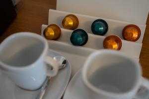 a cup on a plate next to a group of candles at Zenger Hotel in Offenberg +19 photos