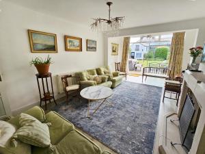 a living room with a couch and a table at Landguard - Yarmouth in Yarmouth