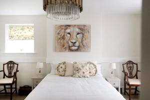 a bedroom with a bed with a lion painting on the wall at Landguard - Yarmouth in Yarmouth