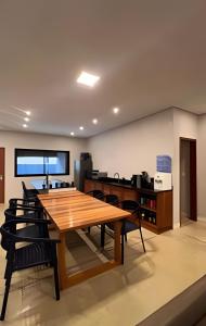 a dining room with a wooden table and chairs at Condominio Uhane Luxury Villas in São Miguel do Gostoso +267 photos