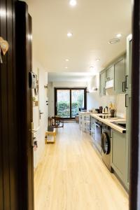 a kitchen with a sink and a dishwasher at Studio Les Epicéas in Boersch