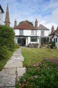 a large white house with a yard with flowers at Landguard - Yarmouth in Yarmouth