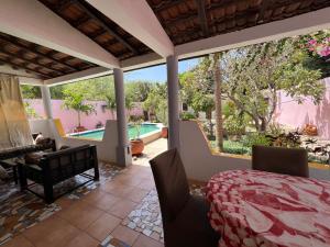 a patio with a table and chairs and a pool at Villa La Somone piscine jardin personnel sur place in Somone