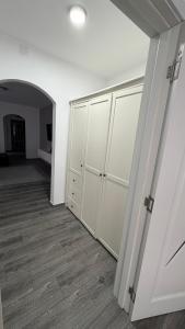 an empty room with white cabinets and a hallway at Luxury Lion Crib2 in Bacău