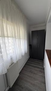 a room with white curtains on the wall at Luxury Lion Crib2 in Bacău +2 photos