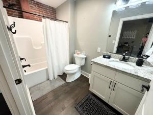 a bathroom with a toilet and a sink and a shower at Studio Apt King Bed Full Kitchen By KeenStays in Cape Girardeau
