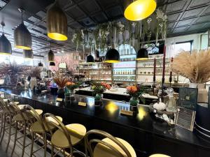 a restaurant with a bar with chairs and lights at Studio Apt King Bed Full Kitchen By KeenStays in Cape Girardeau