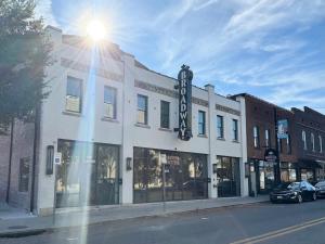 a building with a sign on the side of a street at Studio Apt King Bed Full Kitchen By KeenStays in Cape Girardeau