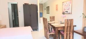 a small dining room with a table and chairs at Shirley Pico de Loro 1BR in Nasugbu