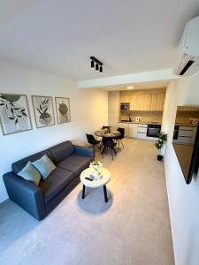 a living room with a couch and a table at Cloud9 Airport Suites in Močići