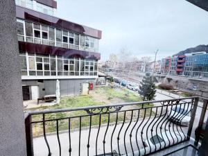 a balcony of a building with a view of a street at Студио за гости АВАНГАРД in Gabrovo