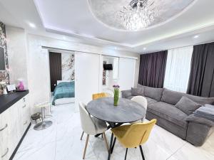 a living room with a table and a couch at Студио за гости АВАНГАРД in Gabrovo