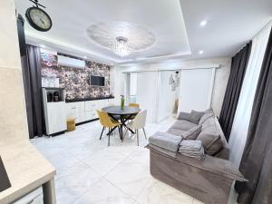 a living room with a couch and a table at Студио за гости АВАНГАРД in Gabrovo +7 photos