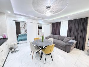 a living room with a table and a couch at Студио за гости АВАНГАРД in Gabrovo