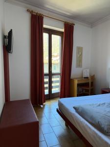 a bedroom with a bed and a large window at Euro Hotel in Edolo