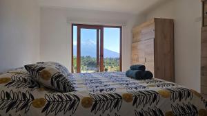 a bedroom with a bed with a view of a mountain at Casa Vulkaan in Puerto Varas