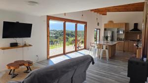 a living room with a couch and a kitchen at Casa Vulkaan in Puerto Varas