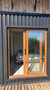 a glass door of a house with two beds at Casa Vulkaan in Puerto Varas