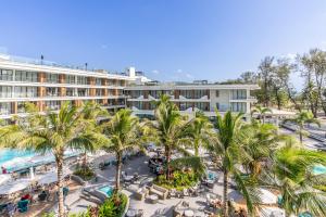 an aerial view of a resort with palm trees and a pool at Sunshine by Villacarte in Layan Beach