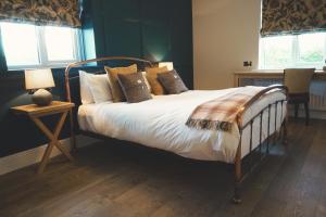 a bedroom with a bed with white sheets and pillows at The Mill at Conder Green in Conder Green +73 photos
