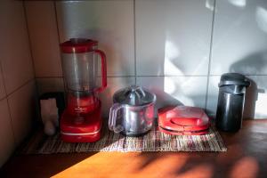 a red blender sitting on top of a counter at Casa Manoel Facão in Atins